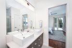 The modern master bath offers double vanity & walk in tile shower.